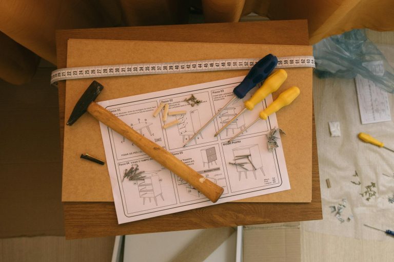 Hammer, screwdrivers, and instructions for assembling furniture. Perfect for DIY enthusiasts.